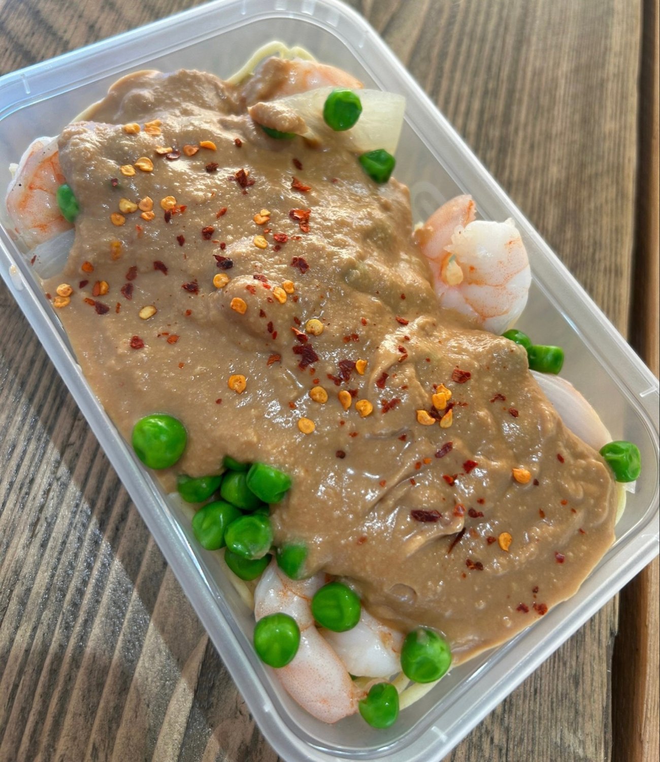 King Prawn served with Wheat Noodles, Peas, Onions and Satay Sauce