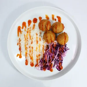 Healthy Sweet Potato Falafel paired with fluffy white rice, rainbow slaw, and drizzled with sweet chilli sauce, offering a vibrant and nutritious meal.