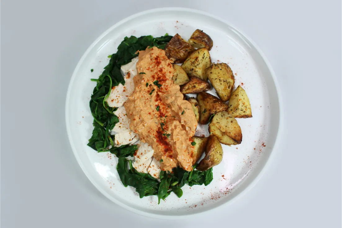 Creamy Tuscan sauce over tender chicken (or other proteins) with spinach and crispy roasted potatoes.