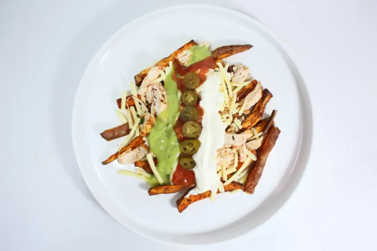 Loaded Fajita Wedges with chicken, sweet potato, fajita-seasoned chicken, melted cheese, salsa, guacamole, crème fraîche, and jalapeños.