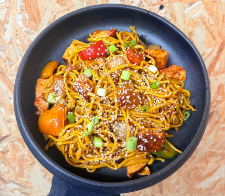 Sweet Chilli Noodles with chicken, peppers, onions and sesame seeds in a glossy sweet chilli glaze